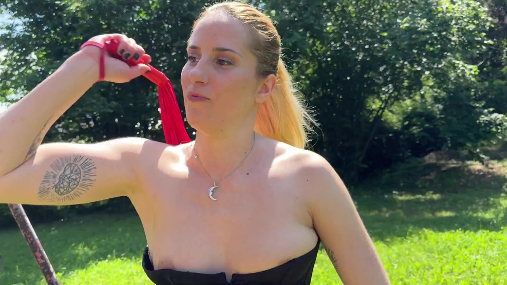 BDSM sub gets whipped by leather domina outdoor